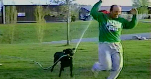 Black Lab Wrestles The Hose Away And Switches It On His Owner