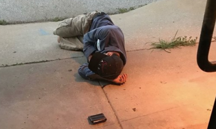 Homeless man wishing to find his lost dog sleeps outside of the shelter